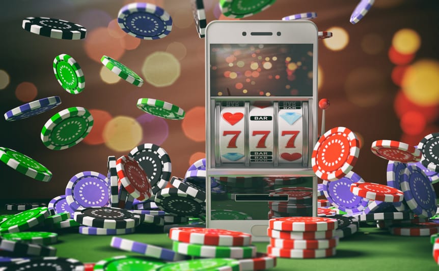 A slots reel on a mobile phone surrounded by casino chips.