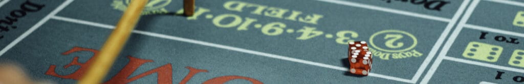 A partial view of a craps table with dice on it.