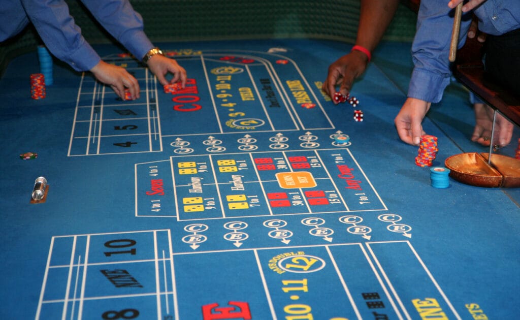 A craps table with people playing.