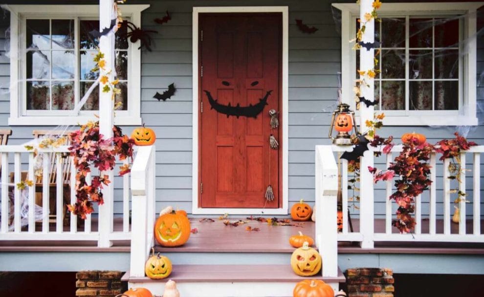 A porch with spooky decorations and jack-o’-lanterns.