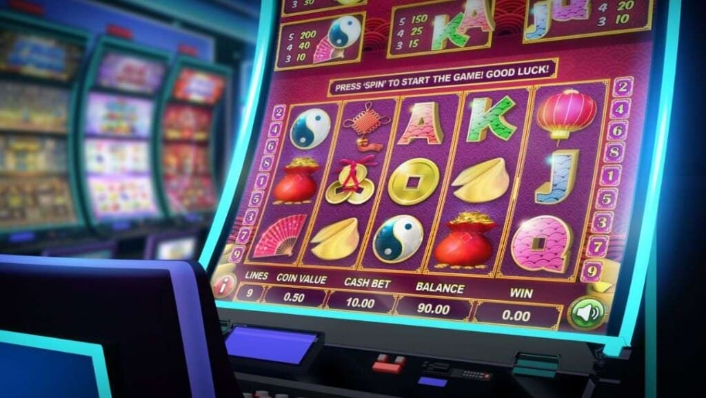 A close-up of the screen of a casino slot machine with an Asian theme. The 5-reel slot game shows various Asian-themed slot symbols along with themed playing card symbols.