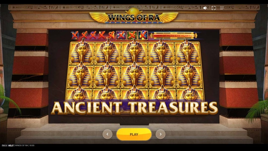 A screenshot of the loading screen from the Wings of Ra slot game. It features a visually striking ancient Egyptian theme set within a grand stone temple framed by carved columns and red-and-beige striped walls. The background suggests regal grandeur with hieroglyphics etched across the upper archway and golden embellishments accenting the header. In the foreground, the reel grid is entirely filled with golden pharaoh symbols, emphasizing a high-paying win scenario. At the bottom, a large golden “PLAY” button is centered, while the phrase ANCIENT TREASURES is boldly displayed in gleaming gold font across the base of the reels.