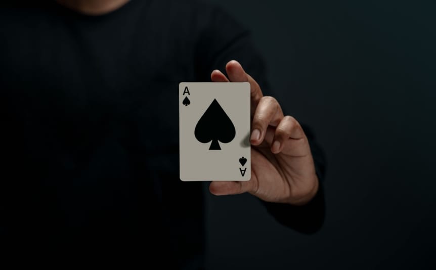 A hand holding a playing card.