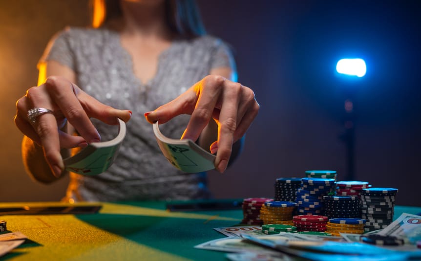 A view of a woman’s hands as she shuffles a pack of cards.