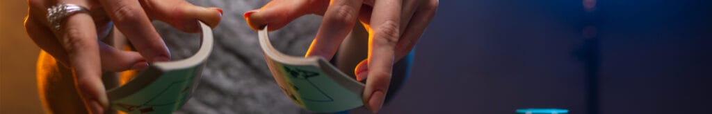 A view of a woman’s hands as she shuffles a pack of cards.