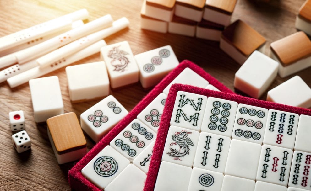 Chinese game-inspired gambling paraphernalia on a wooden table.