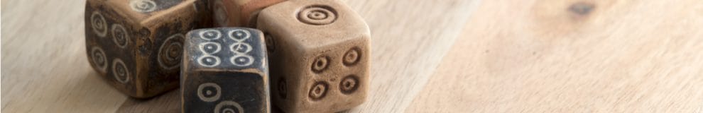 Ancient-looking dice on a wooden table.