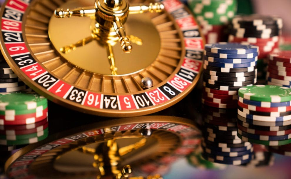 A roulette wheel with the ball in red 23, surrounded by betting chips.