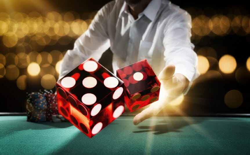 Dice being thrown onto a craps table.
