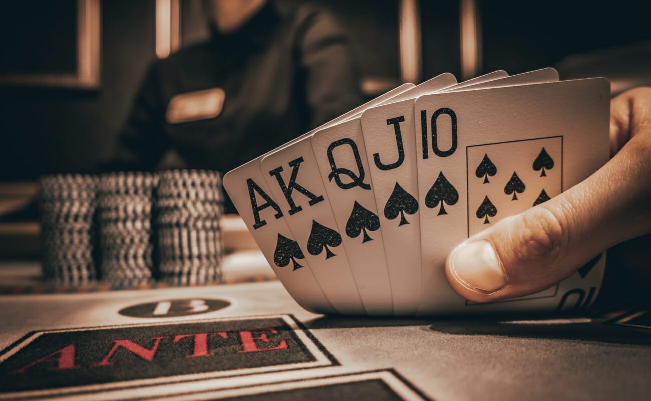 A poker player reveals a royal flush.