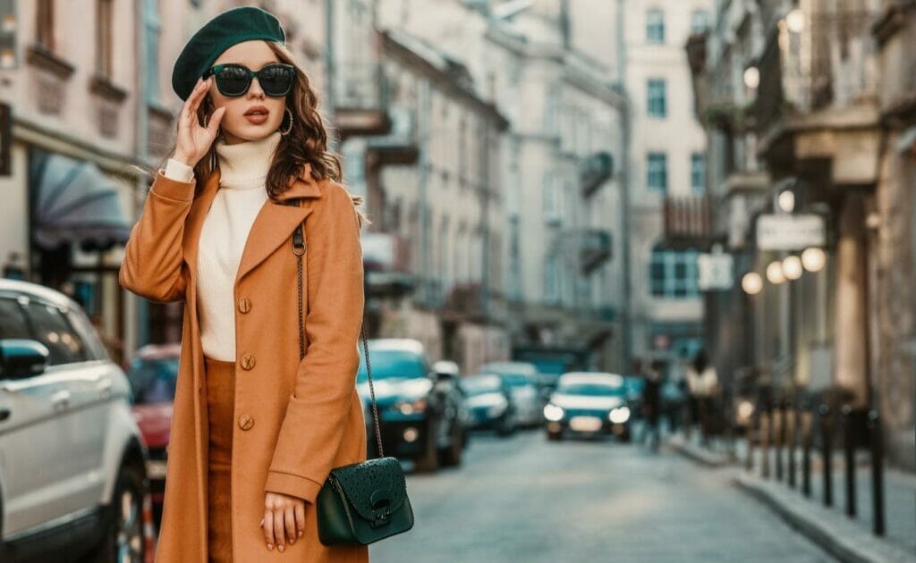 Elegant fashion model walking in the street of a European city.