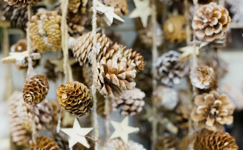 Painted pine cones hanging from strings.