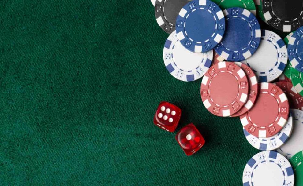  Aerial view of poker chips and dice on a table.