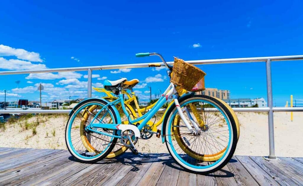 Two vintage bicycles on a boardwalk.
