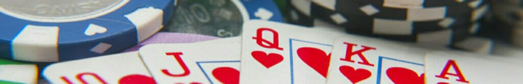 A royal flush sits on top of stacks of poker chips.