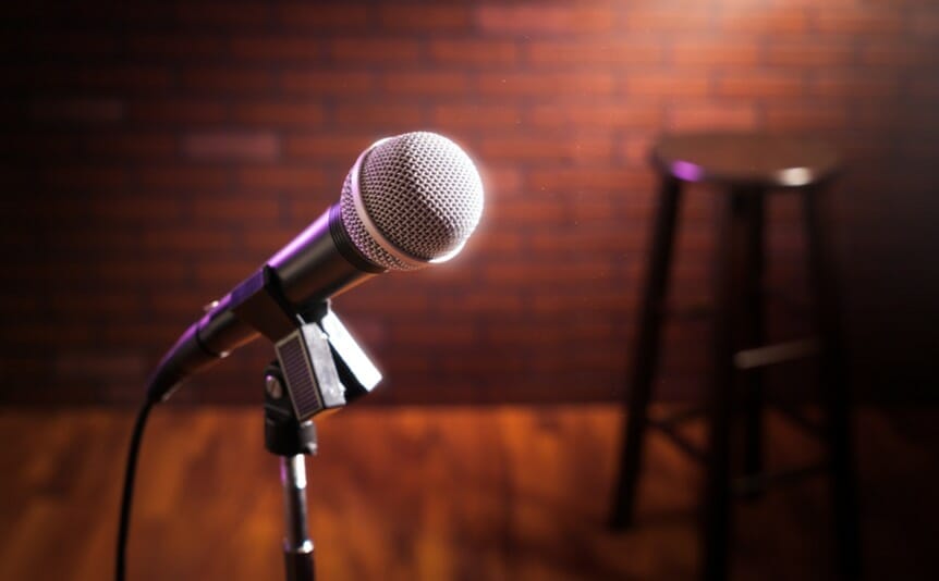 A microphone on a tripod on a stage.