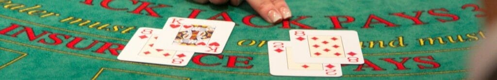Two blackjack hands are dealt on a casino table.