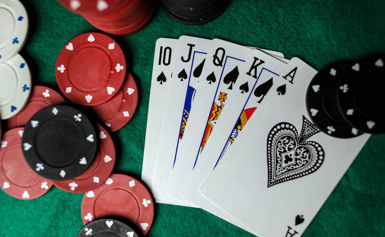 A royal flushing lying among poker chips.