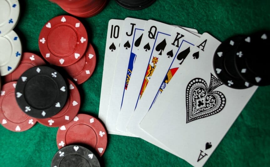 A royal flushing lying among poker chips.