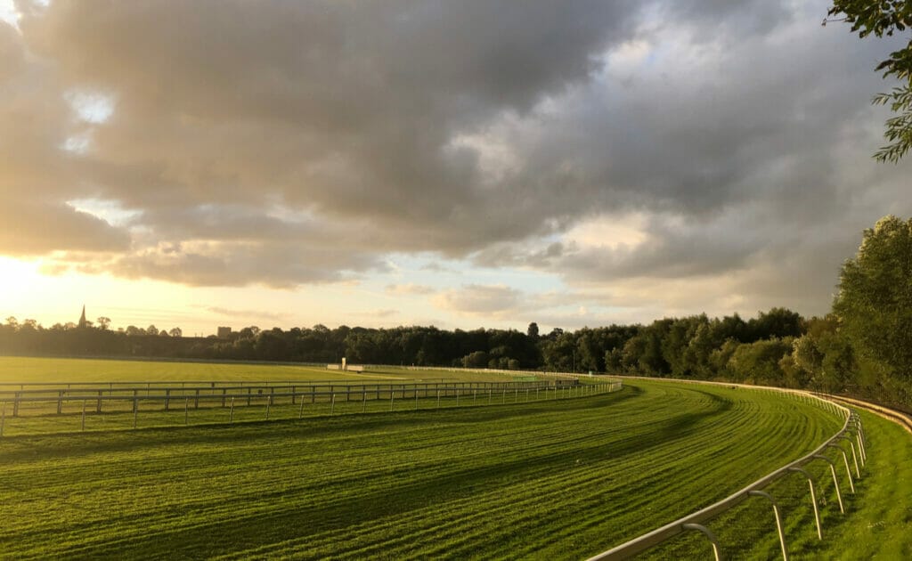 A racetrack at a racecourse in the early morning light.