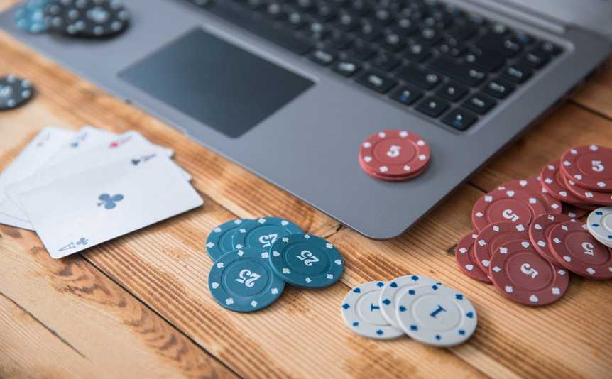 Playing cards, casino chips and a laptop computer.