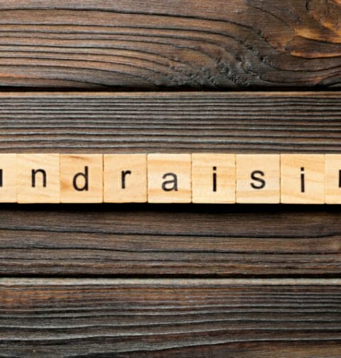 The word “Fundraising” written on wooden blocks.