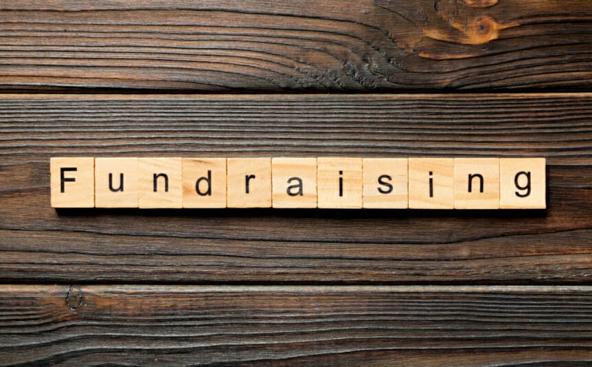 The word “Fundraising” written on wooden blocks.