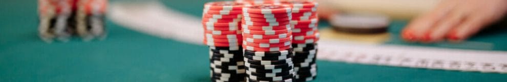 A stack of poker chips on a poker table.