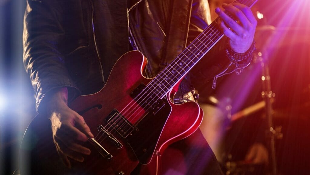 A man playing guitar on stage.