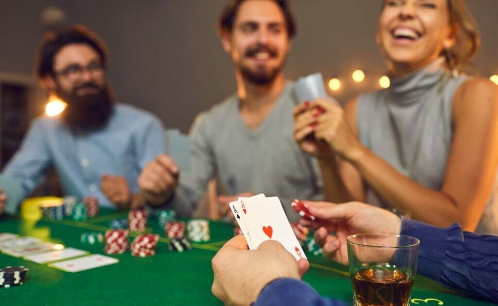A group of friends laughing while playing poker.
