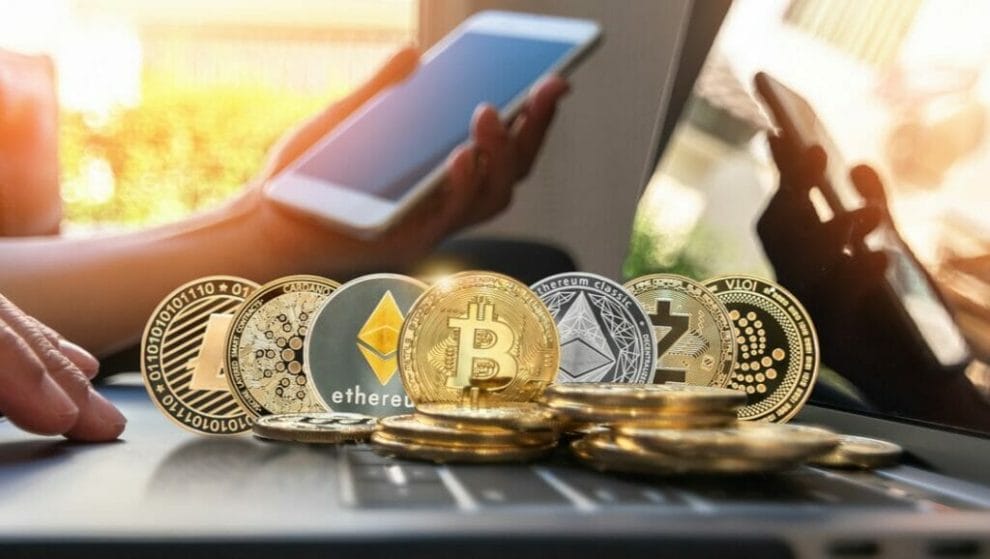 Cryptocurrency coins displayed across a laptop.