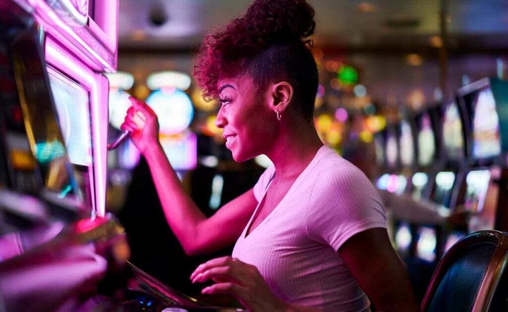 A woman plays a casino slot machine.