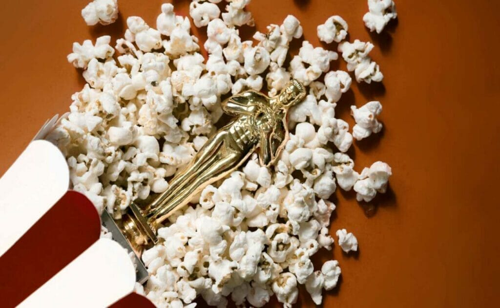 A souvenir Oscar replica on a bed of popcorn.