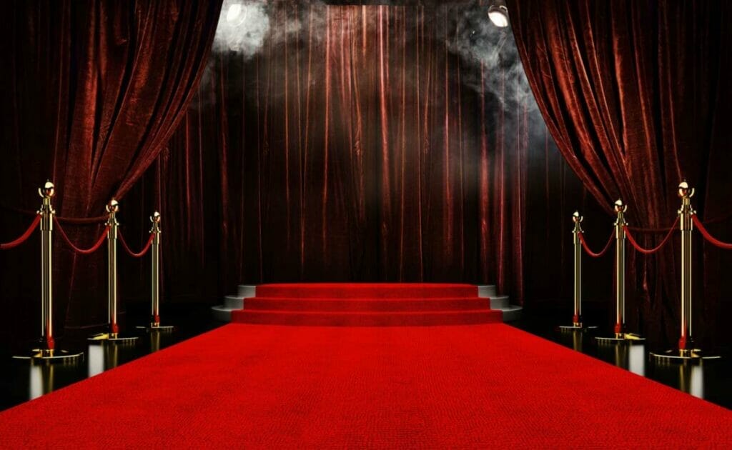  A red stage background with red carpet and smoke.