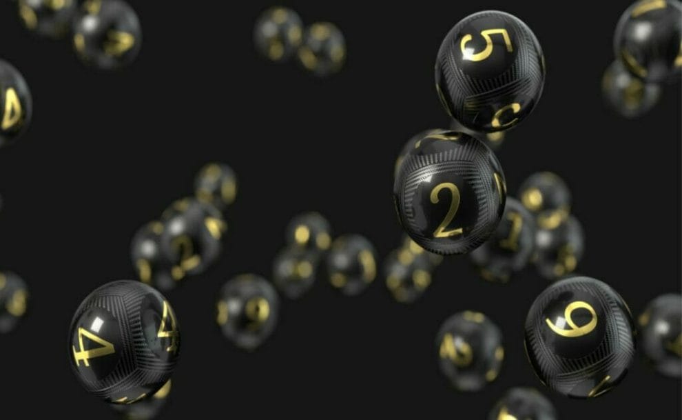 Carbon fiber bingo balls against black background.