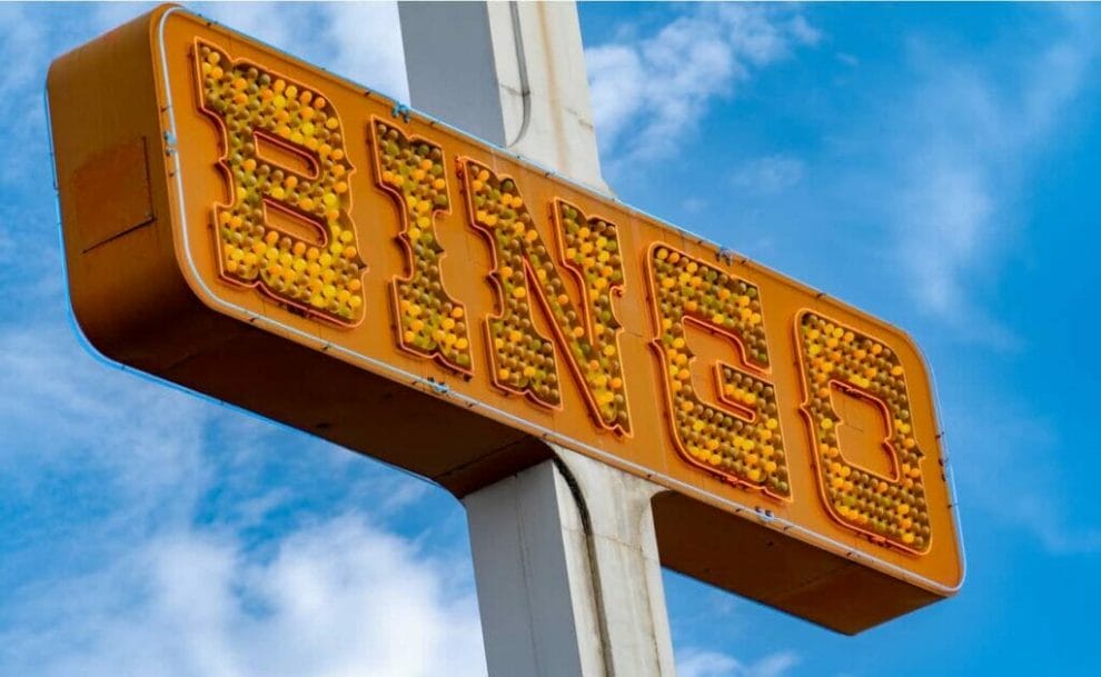  An orange bingo sign with the sky in the background.