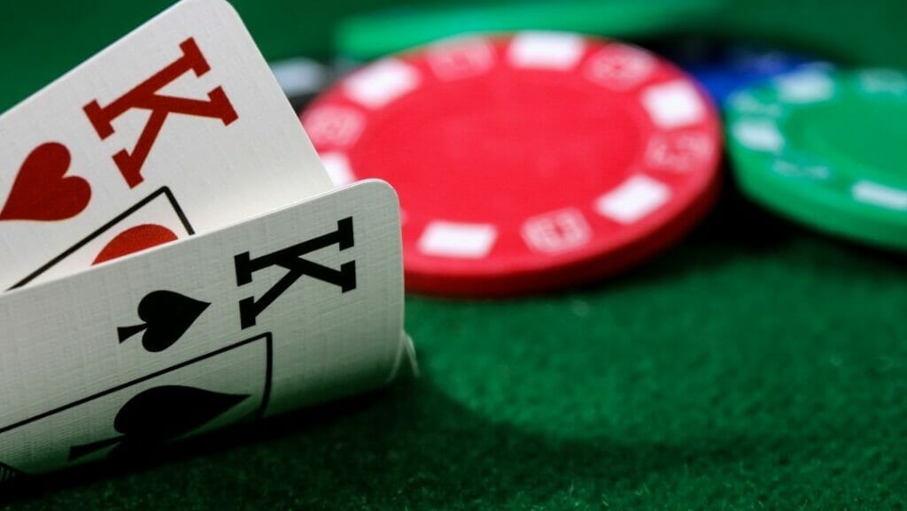 A poker player peeks at their hole cards and sees a pair of kings.