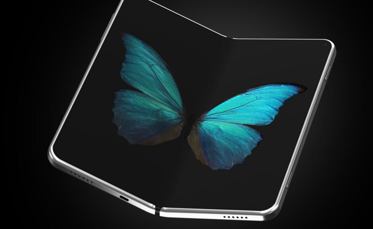 A foldable phone against a black background with a butterfly displayed on the screen.