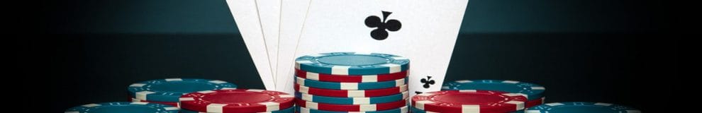 Four aces above stacks of poker chips.