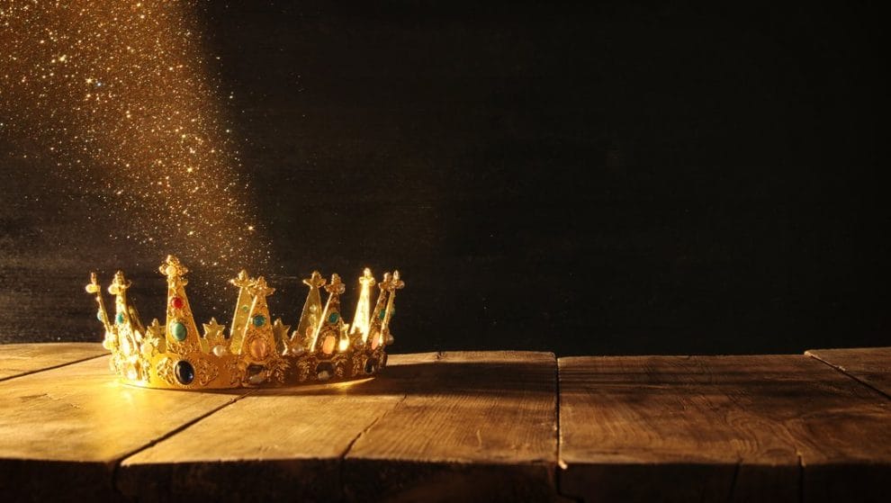 A crown on a table with sunlight falling onto it.