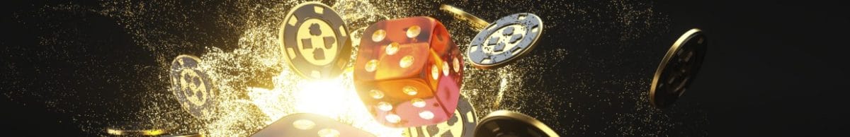 Casino dice and casino chips with gold against a black backdrop.