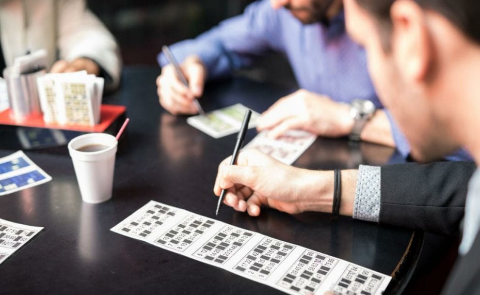 Men playing bingo at a table.