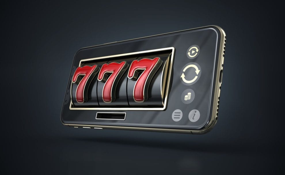 A smartphone with a slot reel on it with the numbers 777.
