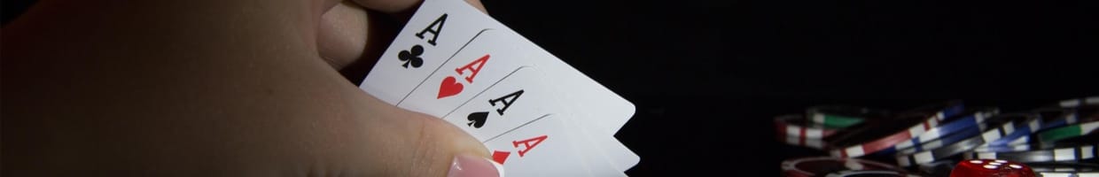 Poker player hand holding 4 A