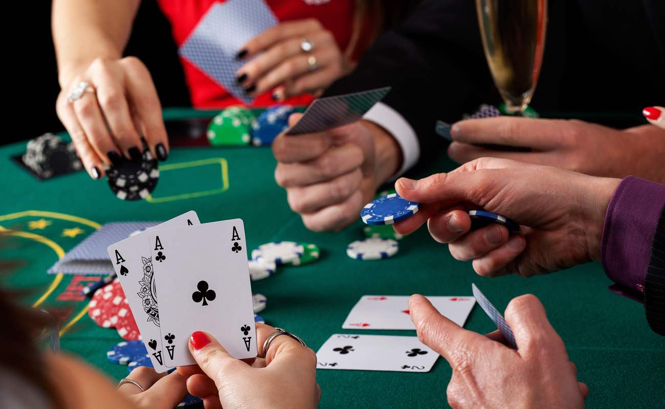 A close-up of two aces during a poker game.