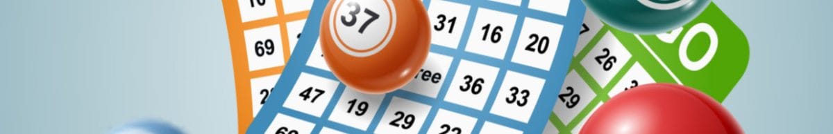 Bingo balls and cards against a light blue background.