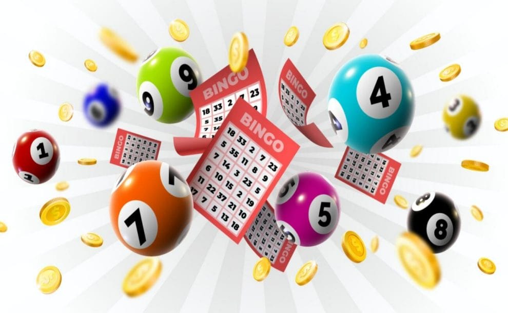 Bingo balls, coins and bingo cards against a white backdrop.