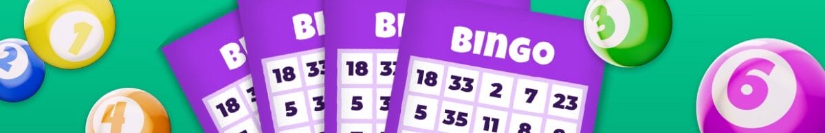 Purple bingo cards and some balls on a green background