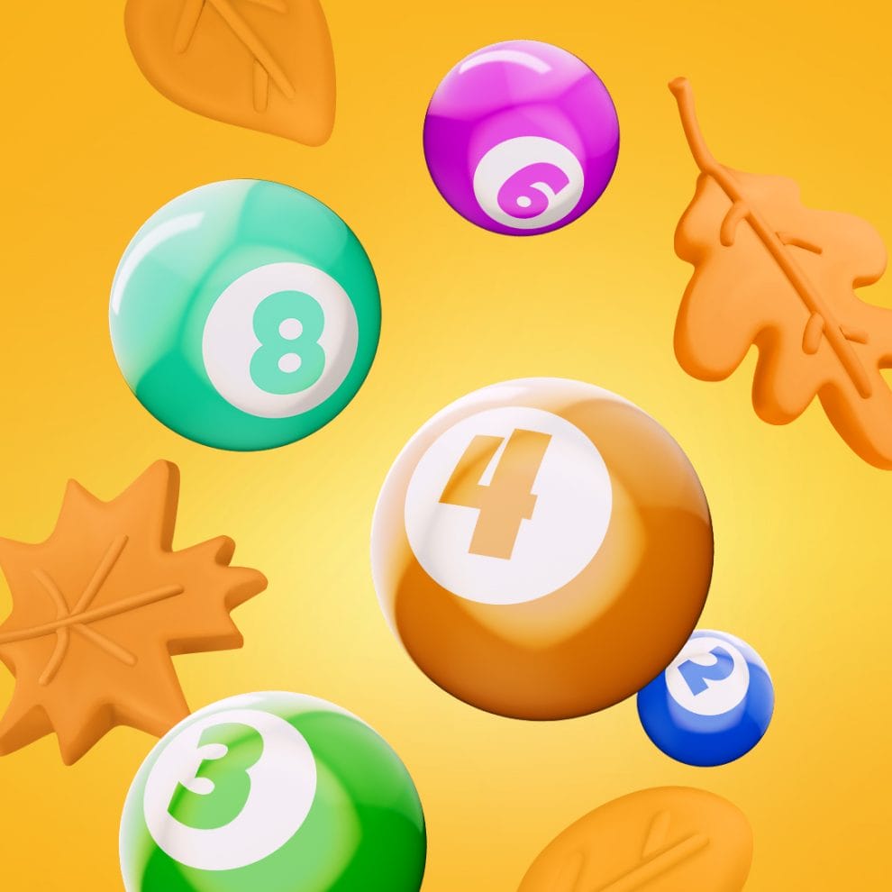 Bingo balls and autumn leaves on a yellow background