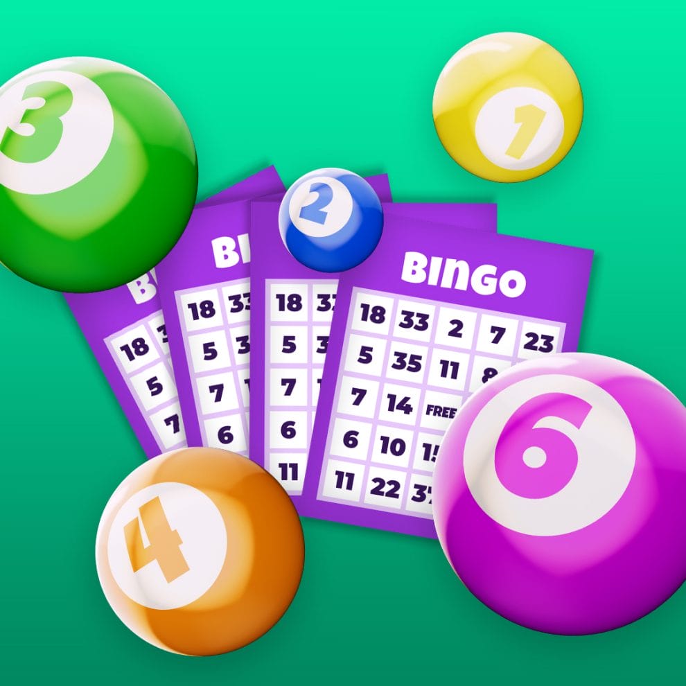 Purple bingo cards with a variety of different ball colors on a green background